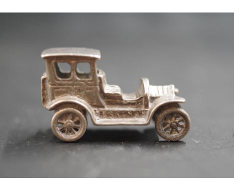 Miniature silver vintage car model marked to reverse of car, (length 3.5cm approx).