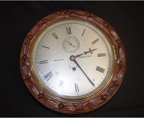 Good 19th Century Oak Cased Marine clock with silvered dial, roman numeral chapter ring and marked "Walsh, Jones Co. London",