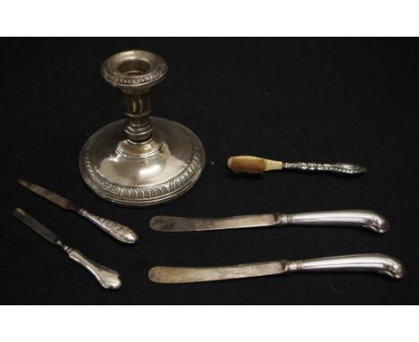 Various silver items including candlestick (weighted), silver handled brush, two knives and 2 manicure items