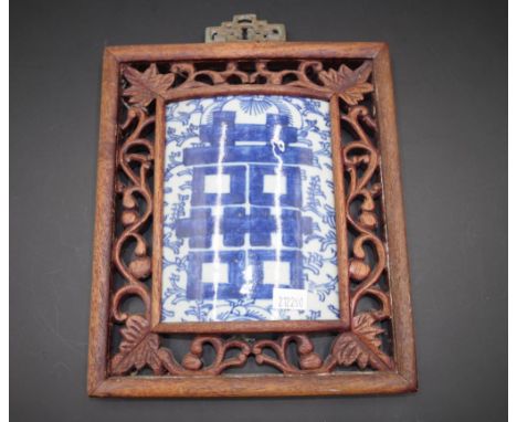 Chinese ceramic tile inset to carved wood frame tile with blue and white painted decoration, inset to carved wood frame, (22c