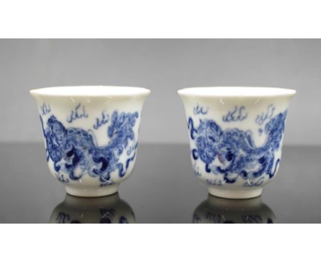 Pair Chinese painted ceramic cups painted blue and white dragon decoration, character marks to bases, (height 6cm approx, eac
