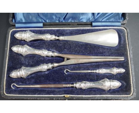 George V sterling silver lady's dressing set Birmingham hallmark to handle of 4 pieces, including: pair glove stretchers, a s