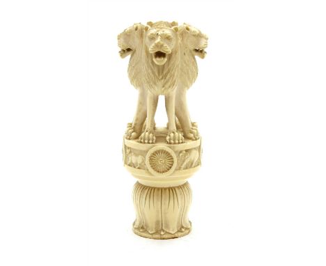 A late 19th century Indian carved ivory finial, comprising four conjoined lions standing on a frieze carved with a horse, a l