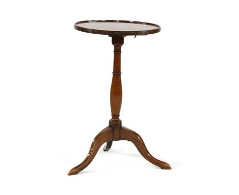 A Regency mahogany tripod table, the circular tilting top with a reeded edge, on a turned column and angular outswept legs, 4