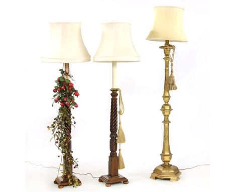 A pair of mahogany standard lamps and shades, with twist turned columns, 160cm high and a giltwood standard lamp and shade, 1