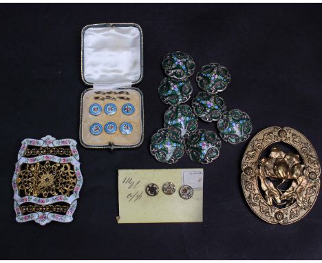 A late 19th Century buckle of filigree, cut steel and white enamel decorated with small pink and mauve flowers; a set of six 