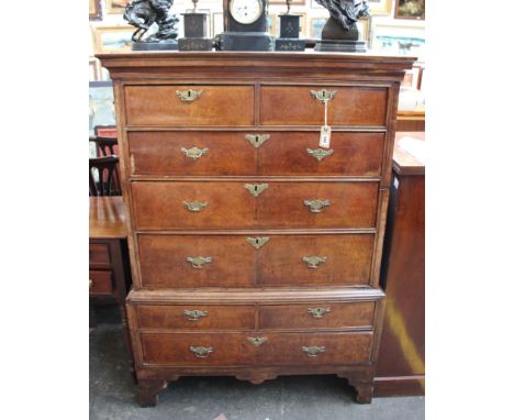 An early 18th century walnut and feather banded chest on chest, two short over three long  drawers, on a base with two short 