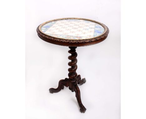 A Victorian walnut games table, with a 'chess board' top and a twisted column, height 73cm, diameter 54cm