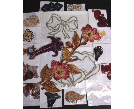 A collection of late 19th and early 20th Century trimmings, including a quantity of embroidered wool flowers, boteh shaped ap