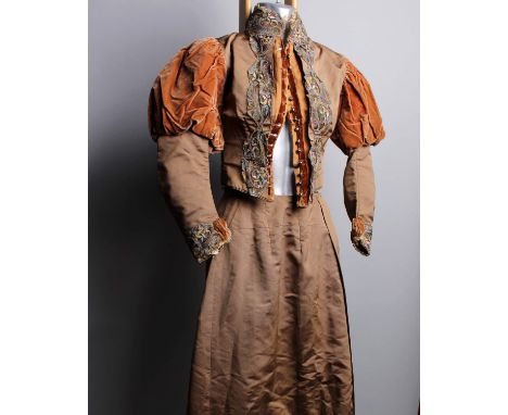 A late 19th Century light brown silk and velvet two piece wedding outfit embellished with coloured lace and velvet ribbon, a 
