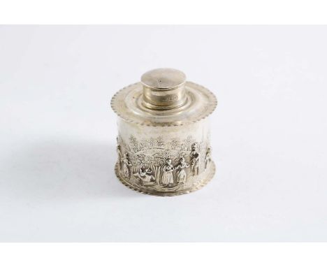 A LATE VICTORIAN EMBOSSED TEA CADDY with crimped borders, a pull-off cap and a happy village scene with figures around the si