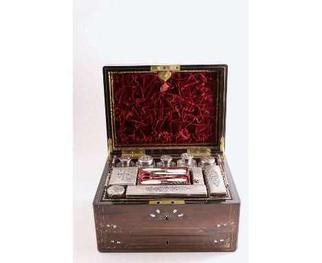 A VICTORIAN INLAID ROSEWOOD DRESSING OR TOILET BOX fitted with ten mounted cut-glass jars/bottles/boxes with engine turned de