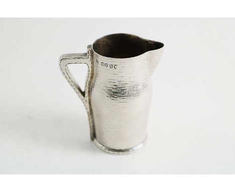 A VICTORIAN NOVELTY CREAM JUG made to a stitched leather jug or "blackjack", with a textured surface & gilt interior, by Edwa