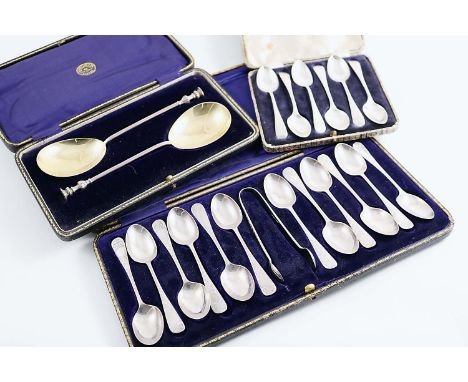 THREE CASED SETS:- A cased set of twelve engraved tea spoons and a pair of matching sugar tongs, maker's mark "A&D", Sheffiel