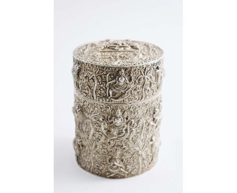 AN EARLY 20TH CENTURY BURMESE CYLINDRICAL BOX OR CADDY profusely chased on embossed with deity figures, animals and palm tree