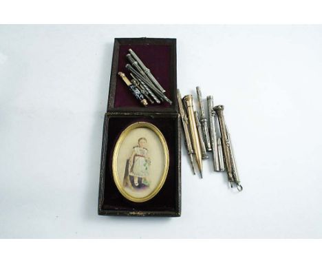 A GROUP OF GILT METAL AND SILVERED PENCILS and one enamelled and a photo portrait in folding case