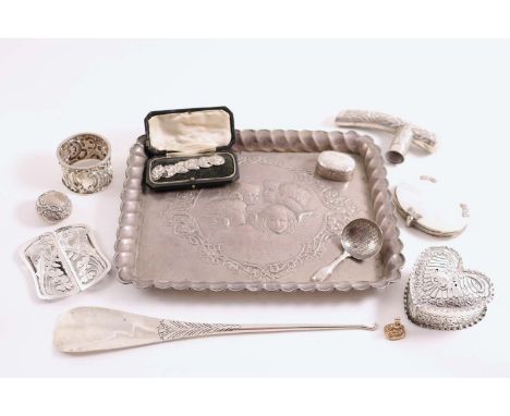 A MIXED LOT:- An Edwardian embossed dressing table tray with cherubs, a heart-shaped trinket box, a napkin ring, a shoe horn,