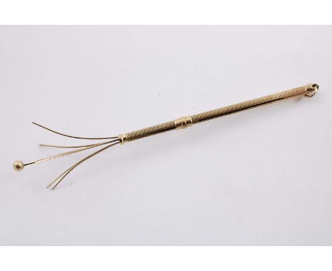 AN ART DECO 9 CT. GOLD COCKTAIL SWIZZLE STICK by Deakin &amp; Francis, Birmingham 1938; 2.75" (7 cms) long closed; 9grams.