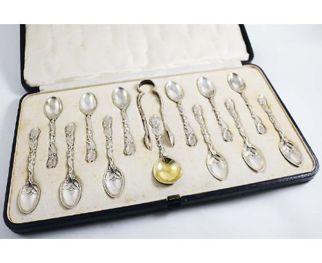 A VICTORIAN CASED SET OF TWELVE CAST NATURALISTIC TEA SPOONS & matching caddy spoon & a pair of sugar tongs, with leafy stems