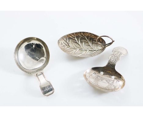 A GEORGE III CADDY SPOON in the form of a leaf with a coiled tendril handle, no apparent maker's mark, Birmingham 1799, an en