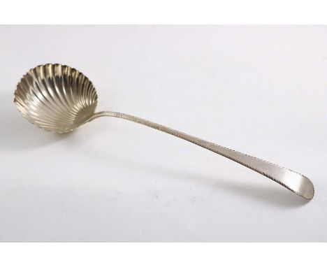 A GEORGE III FEATHER-EDGE SOUP LADLE with a fluted circular bowl, maker's mark "I.S"?, London 1771;  13.25"  (34 cms) long;  