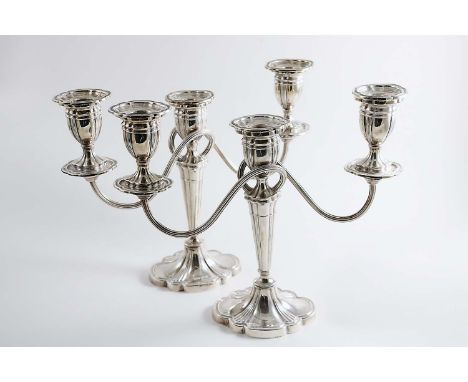 A PAIR OF LATE 20TH CENTURY THREE-LIGHT CANDELABRA  on lobed oval bases with reeded, tapering columns, reeded scroll branches