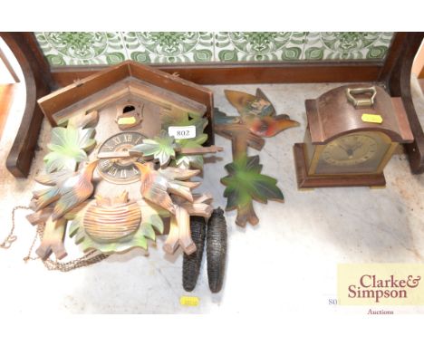 A Black Forest style cuckoo clock and a Tempest Fugit mantel clock