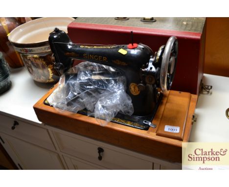 A Singer electric sawing machine in fitted case, sold as collectors item