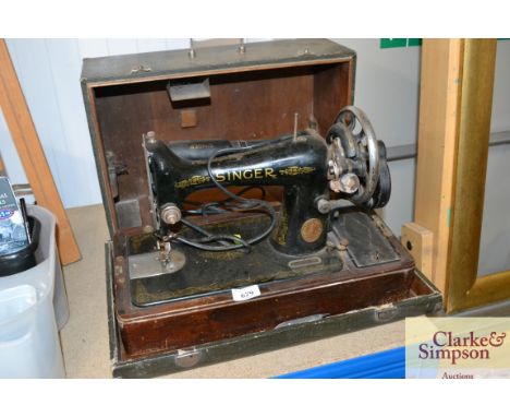 A Singer sewing machine in fitted case, sold as collectors item