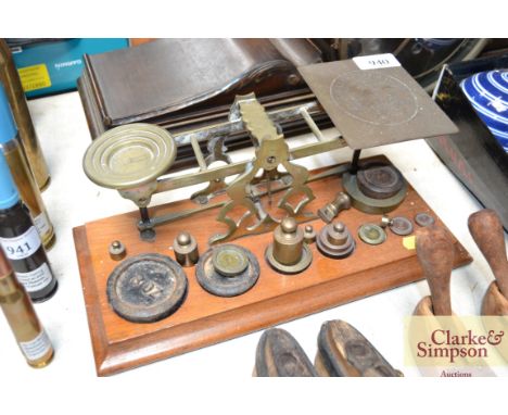 A set of brass postage scales and various weights