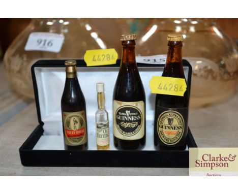 A miniature bottle of Old Fetterkairn scotch whisky; two miniature bottle of Guinness and a Tolley Royal bottle opener in the