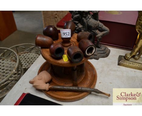 A turned wooden pipe rack and various pipes including Dunhill