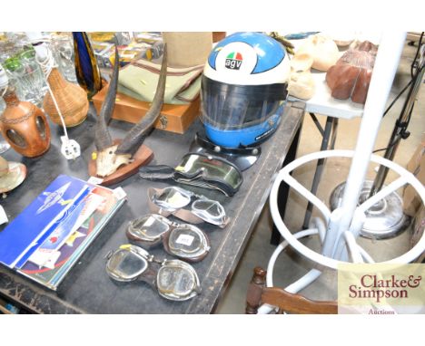 A vintage AGV motorcycle helmet and four pairs of goggles 