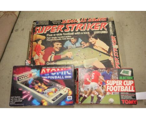 Three boxed vintage games including Parker Super Striker (2 players missing), Tomy Super Cup Football, and Tomy Atomic Pinbal