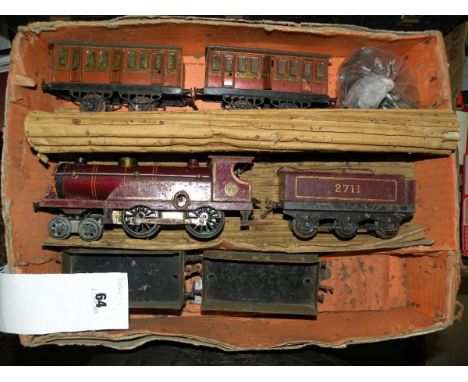 Boxed O gauge Hornby Goods Set with maroon LMS engine with tender, two coaches and two wagons, fairly heavy rusting through t