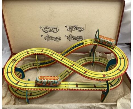 Tinplate: A boxed vintage tinplate Toboggan run, possibly Technofix. 1950’s. Complete with two vehicles and key. Please study