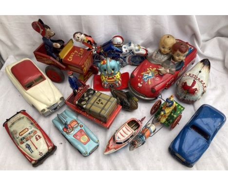 Tinplate: A vintage tinplate collection to include Lawley Toys Crazy Jeep, Police Motorcycle, Porter with luggage, Battery op