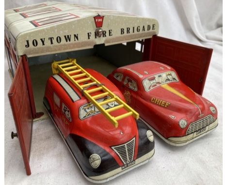 Tinplate: A vintage tinplate Mettoy Joytown Fire Brigade including building, fire chief car and fire engine, both with fricti