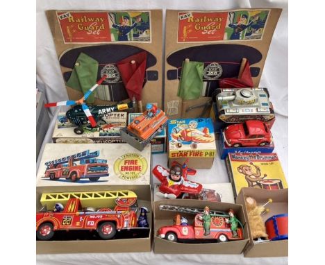 Collectables: A vintage toy collection to include two Kay Railway Guard sets, tinplate fire engines, clockwork helicopter and