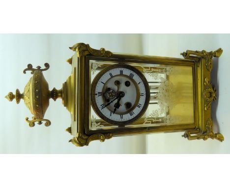 A late 19th century four glass Mantel Clock with white dial and mercury pendulum, in etched bevelled glass and brass case wit