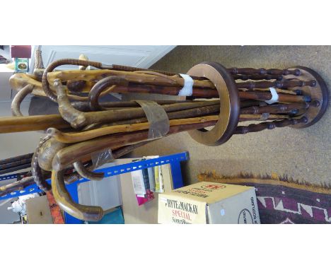 A cylindrical Stick Stand and contents of various walking sticks. 