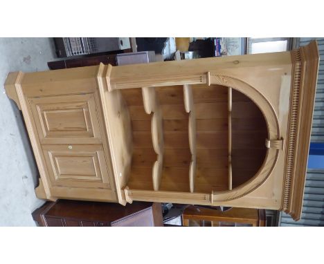 A Georgian design pine standing Corner Cupboard with barrel back and open serpentine fronted shelves beneath a dentil cornice