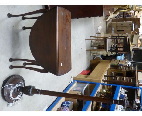A mahogany drop-leaf Dining Table on shaped supports, and a mahogany standard lamp. 