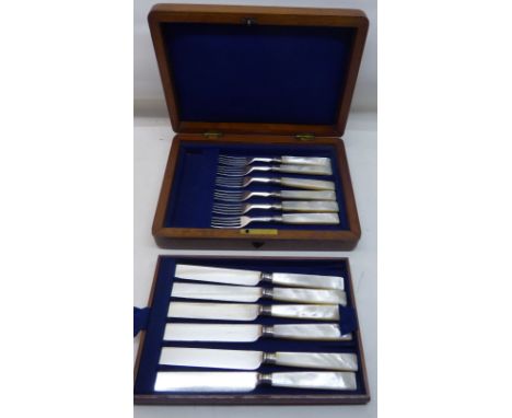 A set of six Dessert Knives and Forks with plated blades and mother of pearl handles, in mahogany box. 