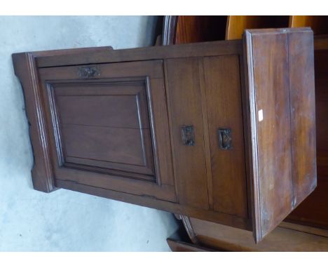 An Edwardian small walnut Side Cabinet with two shallow drawers above a fielded panel cupboard, on bracket feet.  20" (51cms)