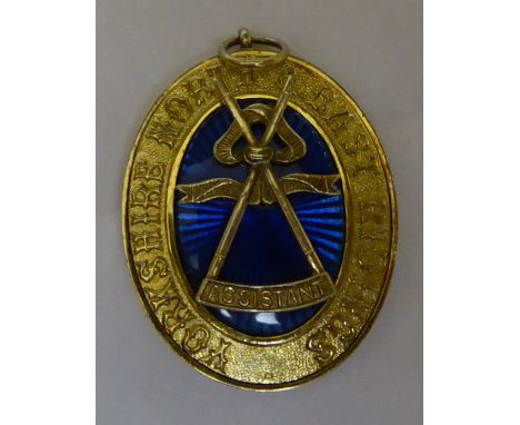 A silver gilt Masonic Jewel with blue enamel decoration by Toye, Kenning & Spencer inscribed "Yorkshire, North & East Riding"