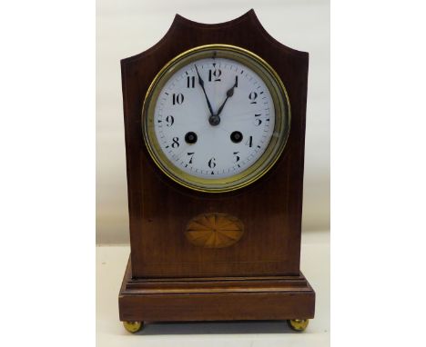 An Edwardian Mantel Clock with white dial, gong strike and French movement, in an inlaid mahogany case.  11" (28cms) high. 