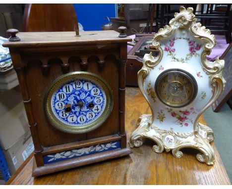 An early 20th century Mantel Clock with floral decorated blue ceramic dial, in an oak case, 10 1/2" (26cms) high, and a mante