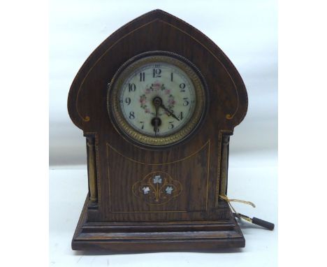 An Art Nouveau design Mantel Clock with floral decorated ivorine dial, in inlaid oak case.  10" (26cms) high. 