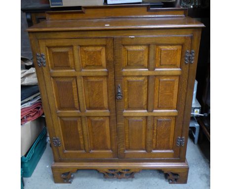 An oak Cupboard with raised back, enclosed by a pair of fielded panel doors, on pierced bracket feet.  3' 4" (102cms) wide. 